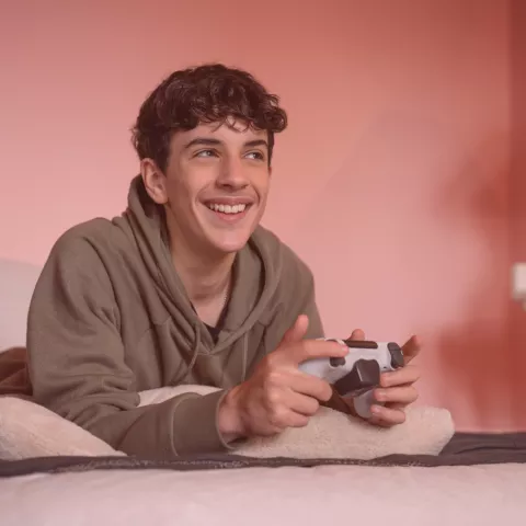 Teenage boy playing video game.