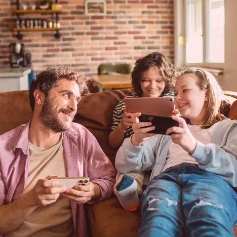 Father and son playing video game on internet.