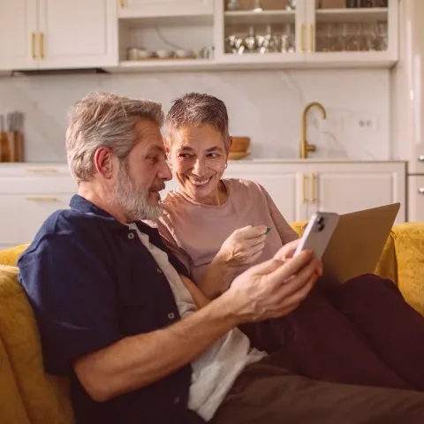 Son showing mobile phone to mum.